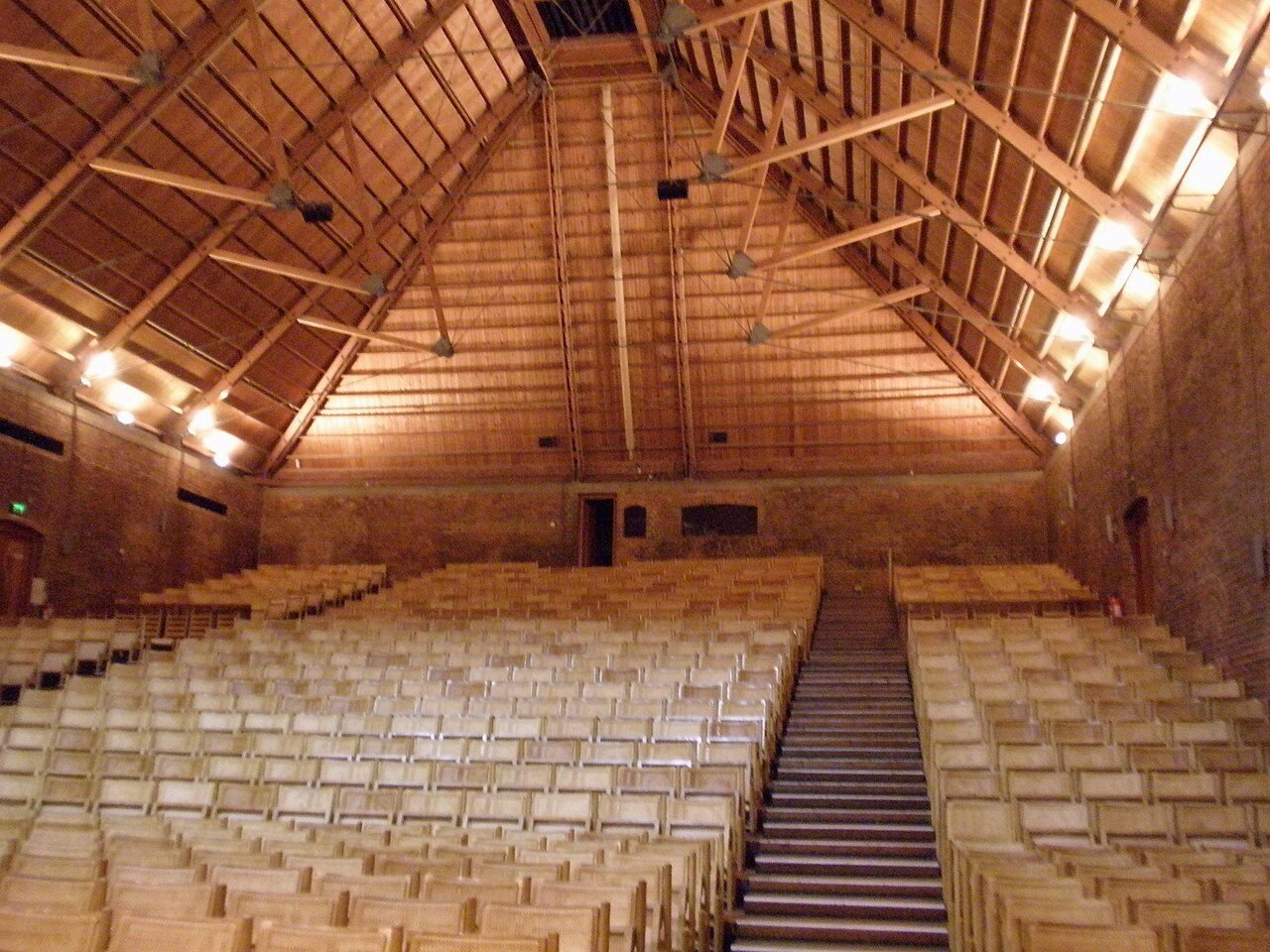 Rows of seats beneath the wooden roof of Snape Maltings Concert Hall in Suffolk.