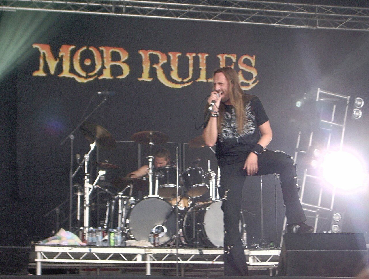 A band on stage in front of its backdrop at Bloodstock Open Air 2008.