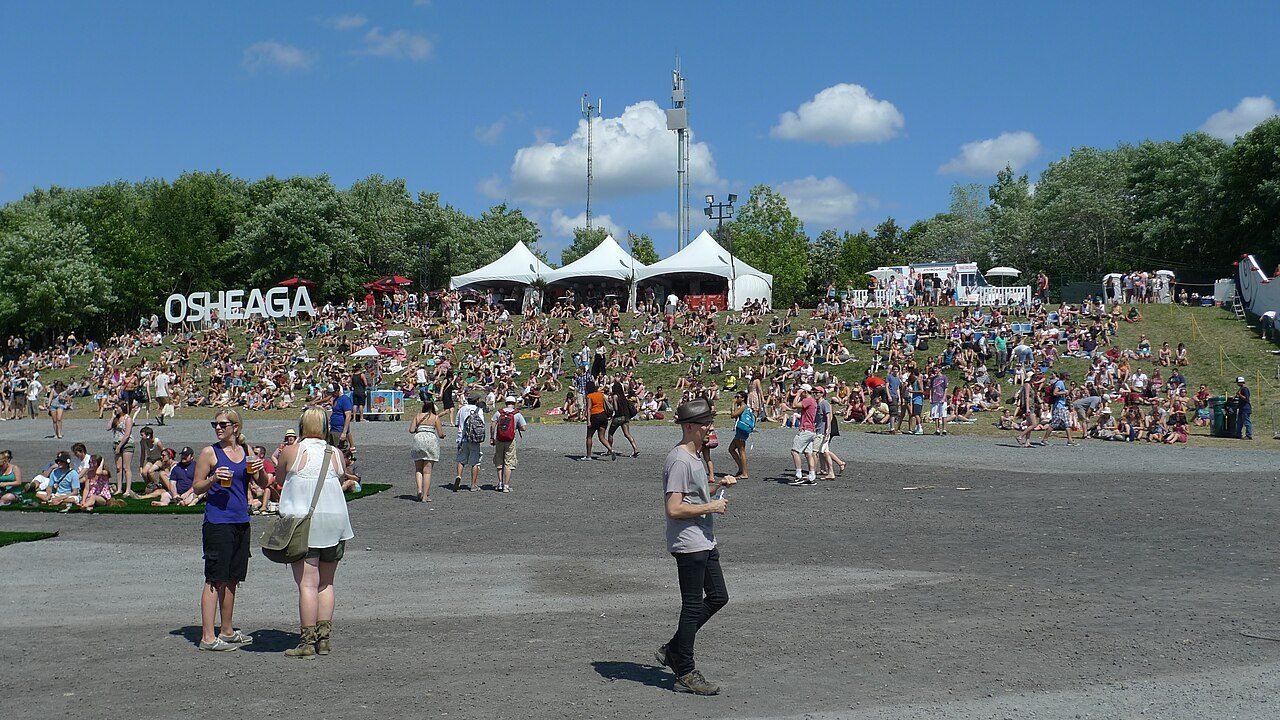 Festival-goers on the open grounds below the Osheaga sign and tents, 2012.